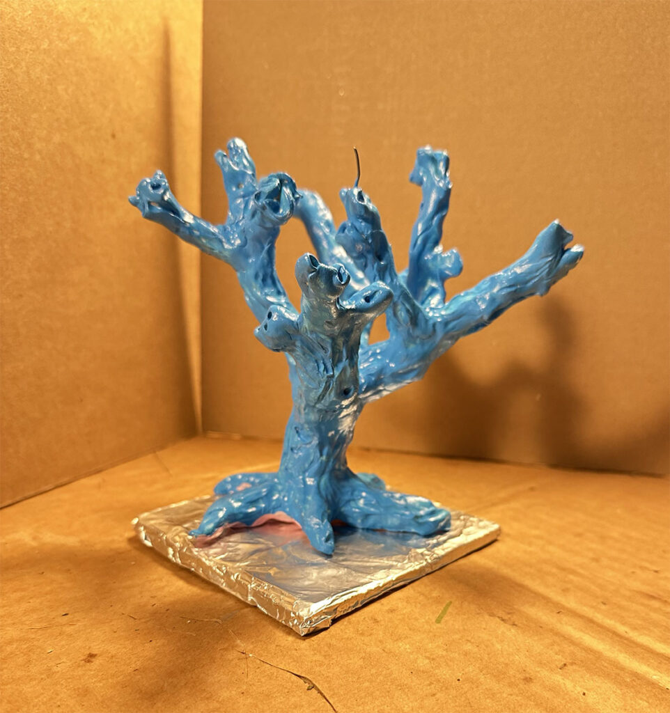 Speaking tree maquette made from polymer clay, painted bright blue.